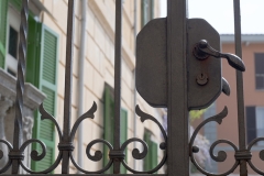 Wrought iron fence, view on traditional houses, Italy